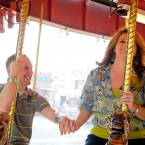 Lotus Blossom Photography Engagement Photo of Couple on Carousel