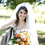 Enchanted Florist Southern Farm Wedding Photo of Bride Leaning on Fence