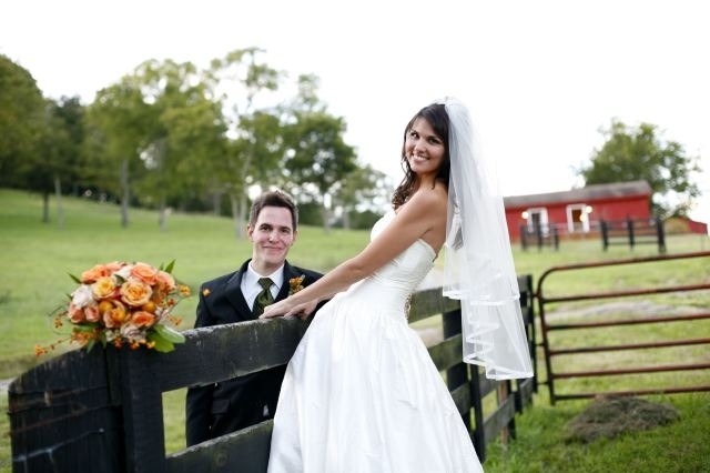 Enchanted Florist Southern Farm Wedding Photo of Bride and Groom Leaning on Fence